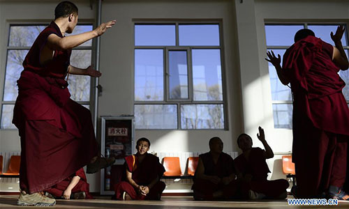  Monks attend a sutra debate at Qinghai Tibetan Buddhism College in Guide County, northwest China's Qinghai Province, Nov. 16, 2016. The first batch of 120 monks have started their four-year full-time study at the newly-opened Tibetan Buddhism college recently. (Xinhua/Zhang Hongxiang)