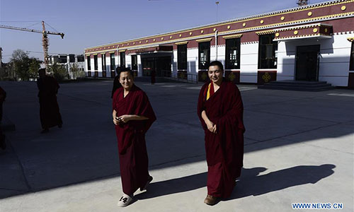  Monks walk past a dining hall at Qinghai Tibetan Buddhism College in Guide County, northwest China's Qinghai Province, Nov. 16, 2016. The first batch of 120 monks have started their four-year full-time study at the newly-opened Tibetan Buddhism college recently. (Xinhua/Zhang Hongxiang)