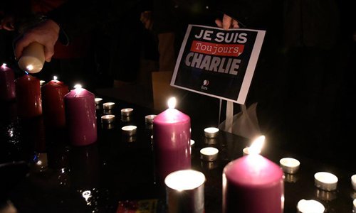 Candles are lit up to commemorate victims of the terrorist attack against Charlie Hebdo in 2015 during a commemoration at the Place of the Republic in Paris, France, on Jan. 7, 2016. Photo: Xinhua