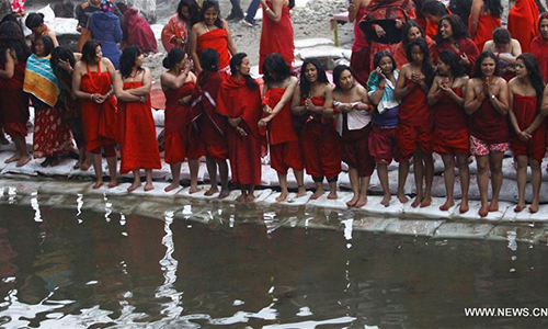Hindu devotees take holy bath in the Shali River on the first day of Madhav Narayan Festival at Sankhu in Kathmandu, Nepal, Jan. 12, 2017. Nepalese Hindu women observe a fast and pray to Goddess Swasthani for longevity of their husbands and family prosperity during the month-long festival. (Xinhua/Sunil Sharma)