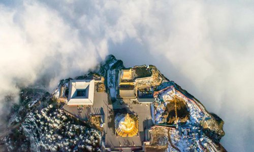Mount Emei in southwest China’s Sichuan Province is shrouded in ethereal-like sea of clouds recently, giving tourists there a spectacular view. An aerial photo shows the golden peak of the Buddhist statue on the mountain peeking through the clouds, giving the illusion that it’s floating there in the sky. Photo: Chinanews.com
