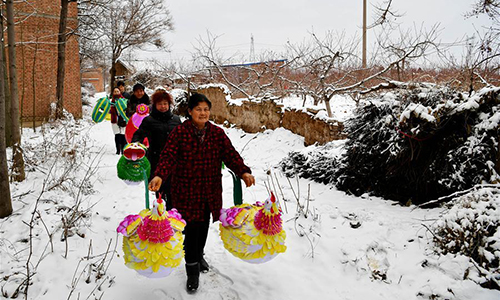 Villagers carry newly-made lanterns for sale in Nan'antou village of Jiaocun town in Lingbao, Central China's Henan province, Feb 8, 2017. Villagers of more than 100 families in Nan'antou are busy making lanterns to ensure market supply of the Lantern Festival.(Photo/Xinhua)