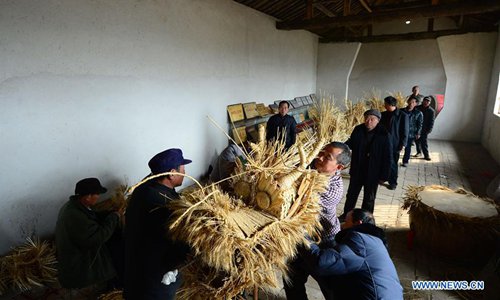 Villagers make a straw dragon in Dahan Village of Hancun Township in Qingfeng County, central China's Henan Province, Feb. 14, 2017. The local straw dragon dance was a pray for rain in ancient time and turned into a folk art nowadays. Photo:Xinhua