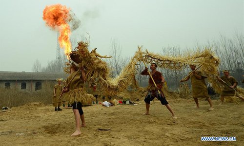 Performers wave a straw dragon in Dahan Village of Hancun Township in Qingfeng County, central China's Henan Province, Feb. 14, 2017. The local straw dragon dance was a pray for rain in ancient time and turned into a folk art nowadays. Photo:Xinhua