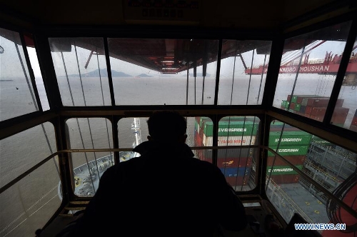A gantry crane driver works at the container terminal at Zhoushan Port in Ningbo, east China's Zhejiang Province, Feb. 16, 2017. The container throughput of Zhoushan Port in 2016 has reached 21.56 million TEU (twenty-foot equivalent unit), up 4.5 percent year-on-year. (Xinhua/Huang Zongzhi)
