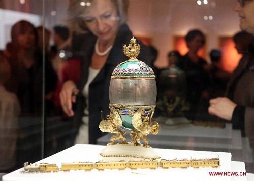 A visitor looks at an Easter egg presented on the exhibition of 