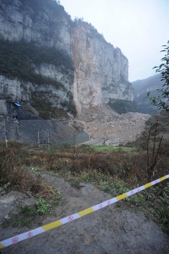 The site of a landslide is blocked at Yudong Village of Longchang Township in Kaili, southwest China's Guizhou Province, Feb. 18, 2013. Five people, including two children, were buried after a landslide hit the village around 11 a.m. Monday. Relief work was hampered as sporadic slides continued. .(Xinhua/Tao Liang) 