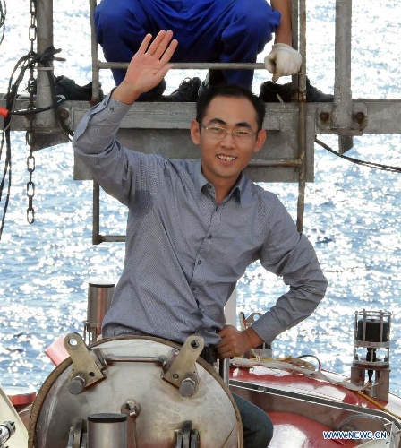 Feng Dong, a researcher from the South China Sea Institute of Oceanology of Chinese Academy of Sciences, prepares to board China's manned submersible Jiaolong for a deep-sea dive into the South China Sea, July 5, 2013. The Jiaolong manned submersible on Friday carried out a scientific dive to collect rock samples from the Jiaolong Seamount in the South China Sea. (Xinhua/Zhang Xudong) 