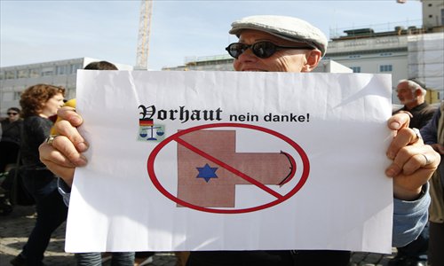 A man holds a banner that reads 