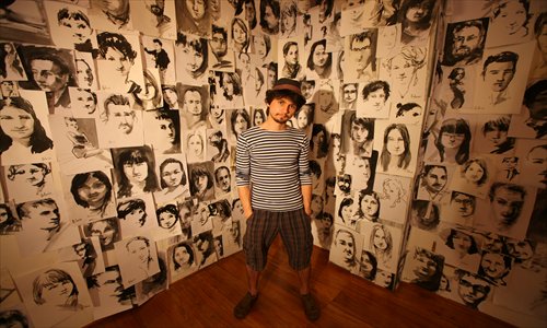 Sergey Balovin in his studio against a backdrop of his portraits Photo: Cai Xianmin/GT