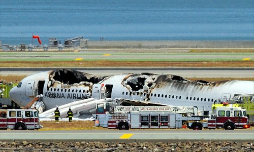 Firefighters surround the ruined Asiana Airlines Boeing 777 on the runway at San Francisco International Airport after crash landing on Saturday. Video footage showed the jet, Flight 214 from Seoul, on its belly. Photo: AFP