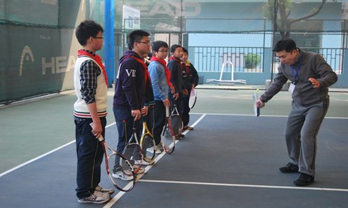 Liu Yu, the founder of the Dianfeng Tennis Club, coaches students in Minhang district. Photo: Courtesy of Liu Yu
