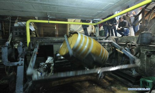 Visitors watch the cleaning of a wooden barrel used to store lambic beer at the Cantillon brewery checks quality of beer in Brussels, capital of Belgium on Nov. 10, 2012. Cantillon brewery, founded in 1900, is one of the few beer brewers still running in Brussels city. It follows traditional way to brew lambic style beers, a unique spontaneous fermented beer only produced in Brussels region. Photo: Xinhua