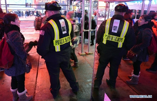 A security member patrols at the Times Square in New York, the United States, Jan. 16, 2013. New York State Governor Andrew Cuomo on Tuesday signed the NY Safe Act following the Assembly has voted overwhelmingly in favor of the bill, which was seen as the toughest gun control law in the nation and the first since the Newtown school shooting. (Xinhua/Wang Lei)