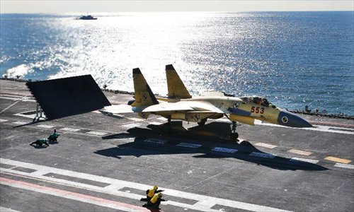 This undated photo shows a carrier-borne J-15 fighter jet ready to take off from China's first aircraft carrier, the Liaoning. China has successfully conducted flight landing on its first aircraft carrier, the Liaoning. After its delivery to the People's Liberation Army (PLA) Navy on Sept. 25, the aircraft carrier has undergone a series of sailing and technological tests, including the flight of the carrier-borne J-15. Capabilities of the carrier platform and the J-15 have been tested, meeting all requirements and achieving good compatibility, the PLA Navy said. Designed by and made in China, the J-15 is able to carry multi-type anti-ship, air-to-air and air-to-ground missiles, as well as precision-guided bombs. The J-15 has comprehensive capabilities comparable to those of the Russian Su-33 jet and the U.S. F-18, military experts estimated. Photo: Xinhua