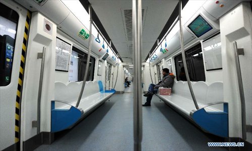 Few passengers are seen on a subway train of the second phase of subway line 10 in Beijing, capital of China, December 30, 2012.