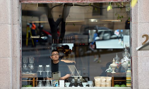 A man looks out a store window in the central business district of Sydney on Wednesday. Australia's unemployment rate eased to 5.5 percent in May, an unexpected fall that could see the central bank hold off on cutting interest rates next month. Economists had tipped a jobless figure of 5.6 percent, the same as the upwardly revised April number. Photo: AFP