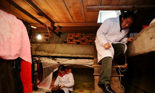  He reaches for something while Xie lays out clothes. Photo: CFP