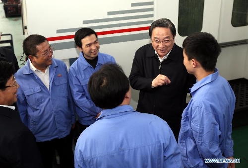 Yu Zhengsheng, a member of the Standing Committee of the Political Bureau of the Communist Party of China (CPC) Central Committee, who is also chairman of the National Committee of the Chinese People's Political Consultative Conference (CPPCC), talks to employees of the Guizhou Aerospace Hongguang Mechanical Manufacturing Co., LTD, in southwest China's Guizhou Province, March 24, 2013. Yu was on an inspection tour in Guizhou from March 24 to March 27. (Xinhua/Yao Dawei) 