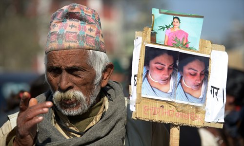 A Nepalese activist gestures as he marches with others near the prime minister's residence in Kathmandu on Thursday, during a protest against the alleged rape and robbery of a maid by government officials.  Photo: AFP 