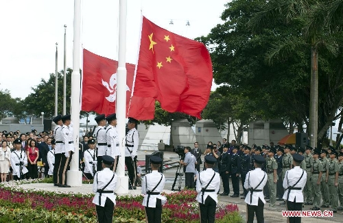 A flag-raising ceremony is held to celebrate the 16th anniversary of Hong Kong's return to the motherland, in Hong Kong, south China, July 1, 2013. (Xinhua/Lui Siu Wai) 