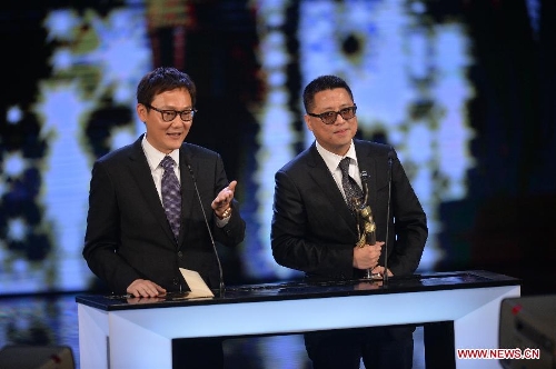 Director Sunny Luk (L) and Lok Man Leung recieve the Best Director award for their movie 
