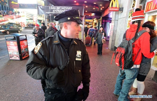 A policeman patrols at the Times Square in New York, the United States, Jan. 16, 2013. New York State Governor Andrew Cuomo on Tuesday signed the NY Safe Act following the Assembly has voted overwhelmingly in favor of the bill, which was seen as the toughest gun control law in the nation and the first since the Newtown school shooting. (Xinhua/Wang Lei)