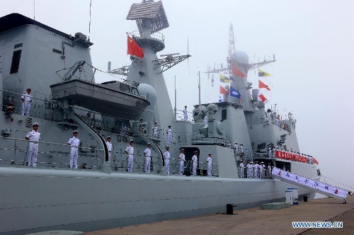 Officers and soldiers of Chinese navy stand on the destroyer Shenyang during a ceremony for the departure of a fleet in the port of Qingdao, east China's Shandong Province, July 1, 2013. A Chinese fleet consisting of seven naval vessels departed from east China's harbor city of Qingdao on Monday to participate in Sino-Russian joint naval drills scheduled for July 5 to 12. The eight-day maneuvers will focus on joint maritime air defense, joint escorts and marine search and rescue operations. (Xinhua/Zha Chunming)