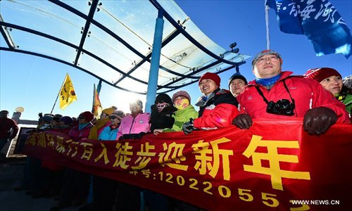 Hikers pose for group photo by Qinghai Lake, northwest China's Qinghai Province, January 1, 2013.