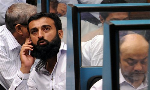 Pakistani stockbrokers watch the latest share prices during a trading session at the Karachi Stock Exchange (KSE) in Karachi on Tuesday. Investors are hopeful of an economic revival under Pakistan's incoming prime minister Nawaz Sharif, whose pro-business policies earned him a good reputation during his two previous tenures in the 1990s. GDP grew 3.7 percent last year but needs to be 6 or 7 percent to absorb population growth. Photo: AFP