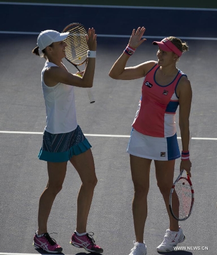 Nadia Petrova (R) of Russia and Katarina Srebotnik of Slovenia celebrate after winning their women's doubles semifinal match against Hsieh Su-Wei of Chinese Taipei and Peng Shuai of China during the BNP Paribas Open in Indian Wells, California, March 14, 2013. Petrova and Srebotnik won 2-0 to enter the final. (Xinhua/Yang Lei) 