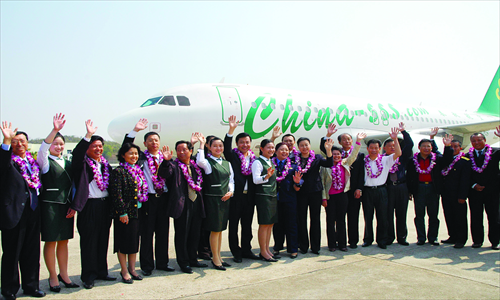 Passengers and staff of Spring Airlines lined up for a ceremony celebrating the launch of its direct flights from Sanya, Hainan Province to Tianjin in February 2007. Photo: CFP