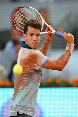 Grigor Dimitrov of Bulgaria returns against Novak Djokovic of Serbia during their match at the Madrid Open tennis tournament in Madrid, Spain on Tuesday. Photo: CFP