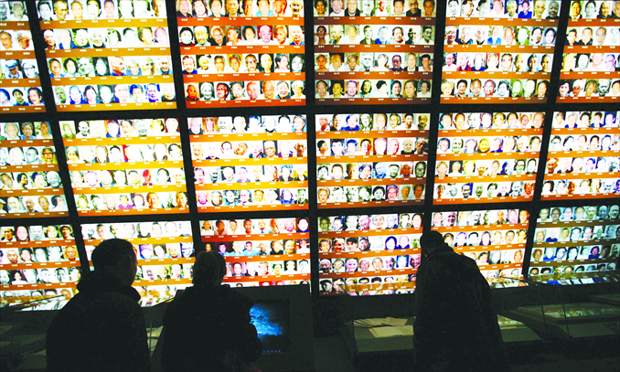 People visit a wall depicting images of survivors at the Memorial Hall of the Victims in Nanjing Massacre by Japanese Invaders on December 7. Photo: CFP