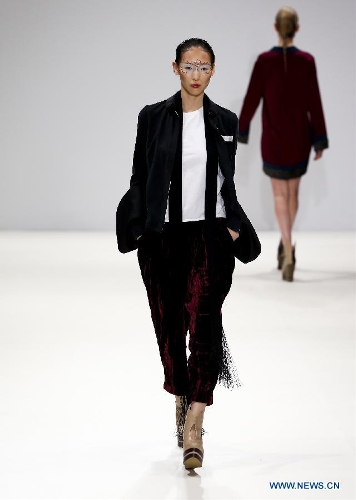 Models present creations of Chinese designer Jenny Ji during London Fashion Week in London, Britain, on Feb. 18, 2013. (Xinhua/Tang Shi)