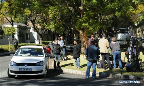 Media workers gather at former South African President Nelson Mandela's Houghton house in Johannesburg, South Africa, on June 25, 2013. South Africans on Monday were holding their breath over former President Nelson Mandela's health that has deteriorated from serious to critical. Mandela, 94, has been hospitalized for a recurring lung problem since June 8. Photo: Xinhua