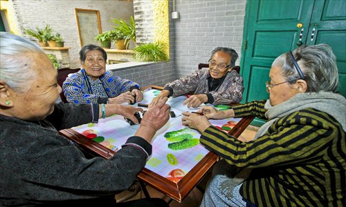 Four zishunü play dominoes after lunch in Jun’an township, Shunde, Guangdong Province. Photo: CFP