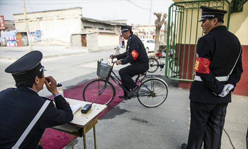 Security guards stand on duty on Monday to register vehicles and people entering Gucheng village in Shunyi district, Beijing, where the city’s first confirmed bird flu case was reported on Saturday. Photo: Li Hao/GT