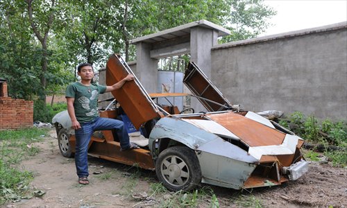 Wang Jian, a villager in Suqian of East China's Jiangsu Province, displays a homemade sports car he modeled after a Lamborghini. He used second-hand parts, costing him 60,000 yuan ($9,445), to make the car. He drives this unique vehicle through his village to carry chemical fertilizer during the harvest season. Photo: CFP