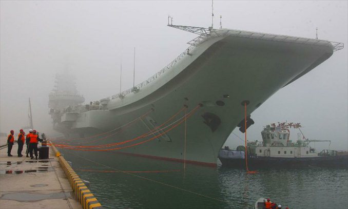 China's first aircraft carrier, the Liaoning, anchores at its homeport in Qingdao, east China's Shandong Province, Feb. 27, 2013. It is the first time for the aircraft carrier to anchor at its homeport, meaning that the naval base for aircraft carrier in Qingdao is operational after four years of construction, according to a People's Liberation Army Navy statement. Photo: Xinhua