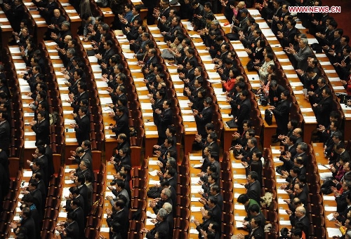 Members of the 12th National Committee of the Chinese People's Political Consultative Conference (CPPCC) applaud at the closing meeting of the first session of the 12th CPPCC National Committee at the Great Hall of the People in Beijing, capital of China, March 12, 2013. (Xinhua/Qin Qing)