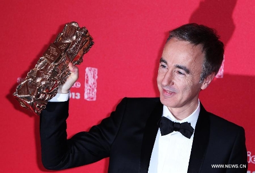 French director Sebastien Lifshitz holds his Best Documentary Award for 'Les Invisibles' as he poses for photos during the 38th annual Cesar awards ceremony held at the Chatelet Theatre in Paris, France, Feb. 22, 2013. (Xinhua/Gao Jing)