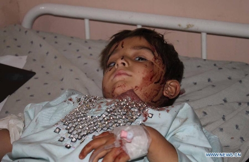 &nbsp;A wounded child receives treatment at a hospital in Kandahar, Afghanistan, on May 17, 2013. At least nine people were killed and more than 55 others wounded Friday evening when two back-to-back explosions rocked Kandahar city, capital of the southern Afghan province of Kandahar, a provincial government spokesman said. (Xinhua/Arghand)