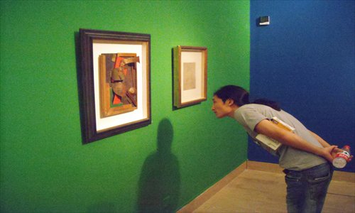 A visitor observing artworks on display at the constructivism exhibition. Photo: Zhang Zihan/GT