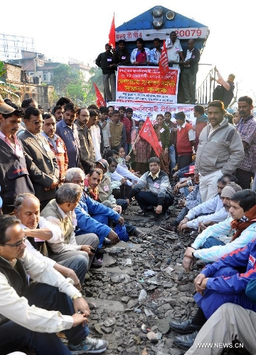 Activists of trade unions block a railway during a nationwide strike in Guwahati, capital city of India's northeastern state of Assam, Feb. 20, 2013. Indian unions started a two-day strike Wednesday to protest high inflation, privatization of public sector and alleged anti-labor policies by the Congress-led government. (Xinhua/Stringer) 