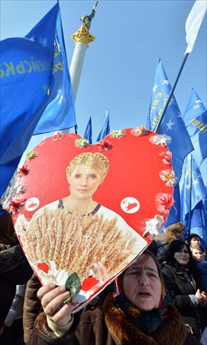 A person holds a heart-shaped placard bearing a picture of jailed former prime minister Yulia Tymoshenko during a rally called 
