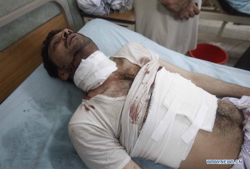 A wounded man receives medical treatment at a hospital in Jalalabad, capital of east Afghanistan's Nangarhar Province, May 15, 2013. A policeman was killed, another policeman and seven civilians were wounded when an IED went off in Jalalabad on Wednesday. (Xinhua/Tahir Safi)