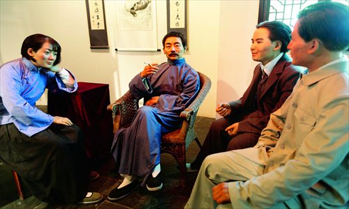 A sculpture of Lu Xun, the famous Chinese novelist (1881-1936), sits smoking in the China Tobacco Museum. Photo: CFP