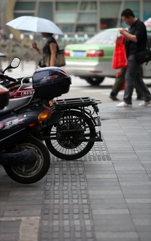 Motorcycles and mopeds block the pathways for the blind around Shanghai Railway Station in Zhabei district. Photo: Cai Xianmin/GT

