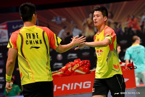 Cai Yun (R) and Fu Haifeng of China encourage each other during the 2013 Sudirman Cup world mixed team badminton championship against Indonesia's Hendra Setiawan and Angga Pratama in Kuala Lumpur, Malaysia, on May 21, 2013. The Chinese pair won 2-1. (Xinhua/Chong Voon Chung) 